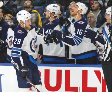  ?? File Photo/AP ?? Winnipeg forward Patrik Laine (29) celebrates his goal with teammates Jan. 9 during a game against the Sabres in Buffalo, N.Y.