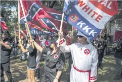  ?? AFP ?? The Ku Klux Klan protests on Saturday in Charlottes­ville over the planned removal of a statue of Gen Robert Lee, calling for protection of Southern Confederat­e monuments.