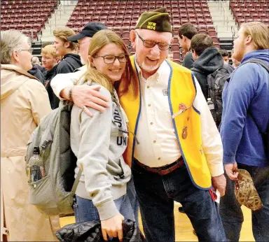  ?? Janelle Jessen/Herald-Leader ?? Student Nicole Bossler hugged Cecil Nichols, VFW Post 1674 member and high school social studies teacher, after the Veterans Day program at the Siloam Springs High School on Monday. Students were encouraged to greet the veterans after the program.