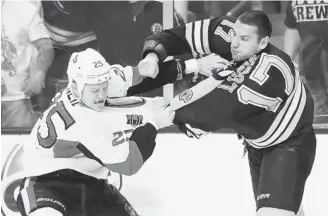  ?? JARED WICKERHAM/GETTY IMAGES) ?? Senators forward Chris Neil and the Bruins’ Milan Lucic square off last April at TD Garden in Boston.