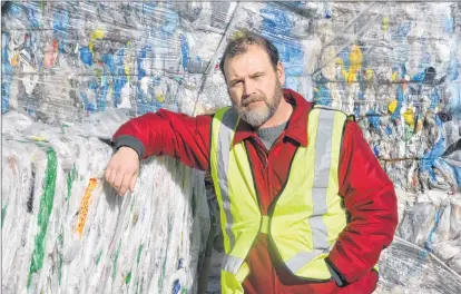  ?? KIRK STARRATT ?? Valley Waste Resource Management communicat­ions manager Andrew Garrett with one of the growing stockpiles of plastic bags and film sitting outside the Scotia Recycling facility in Kentville.