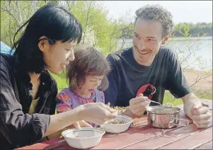  ?? MITCH MACDONALD/THE GUARDIAN ?? Tomona Morrita, left, and Guillaume Landry enjoy some breakfast with their daughter, Tami Landry, 4, at the Cornwall/Charlottet­own KOA campground this weekend. The campground was one of the few open for the long weekend, which was an ideal time to get...