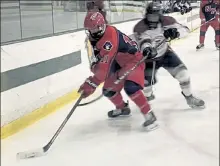  ?? NICK MALLARD / SENTINEL & ENTERPRISE ?? North Middlesex Regional's Jimmy O'Keefe, left, shields the puck from Fitchburg/Monty Tech's Max Beaulac during Monday's game.