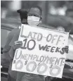  ?? JOE RAEDLE Getty Images ?? Joseph Louis joins others in a protest asking the state of Florida to fix its unemployme­nt system on May 22, 2020 in Miami Beach.