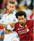  ??  ?? Ruthless: Ramos fouls Salah