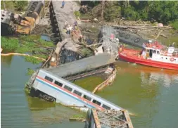  ?? AP PHOTO/MARK FOLEY, FILE ?? This Sept. 22, 1993, photo shows wreckage of the Amtrak Sunset Limited train north of Mobile, Ala. A barge hit a railroad bridge, and minutes later the train hit the bent tracks and plunged into the bayou, killing 47 people and injuring more than 100...