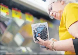  ?? [COURTNEY HERGESHEIM­ER/DISPATCH] ?? Katurah Darling checks out blueberrie­s for sale at Community Markets in Bellefonta­ine. Another local, independen­t market also accepts the produce vouchers used in Ohio’s pilot program.