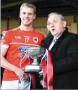  ??  ?? Danny O’Flynn, captain of Charlevill­e Intermedia­te Hurling team accepting the Munster Trophy after they defeated the Clare champions Feakle last Sunday.