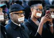  ?? THE OKLAHOMAN/Steve Sisney/The Associated Press ?? George Henderson, left, professor emeritus, joins students at the University of Oklahoma to protest a fraternity’s racist
comments on Monday in Norman, Oklahoma.