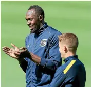  ??  ?? Michael McGlinchey, right, chats to Usain Bolt during a Central Coast Mariners training session.