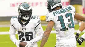  ?? DONWRIGHT/AP ?? Running back Miles Sanders (26) and wide receiver Travis Fulgham were bright spots for the Eagles offense in Sunday’s 38-29 loss to the Steelers.