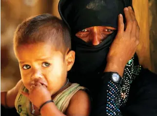  ??  ?? Rohingya refugee cries next to her son, outside a temporary mosque at Kutupalong refugee camp, near Cox’s Bazar, Bangladesh on Thursday. (Reuters)