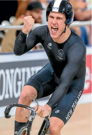  ?? PHOTOSPORT ?? This is what it means to win a gold medal: Sam Webster enjoys New Zealand’s team pursuit triumph.