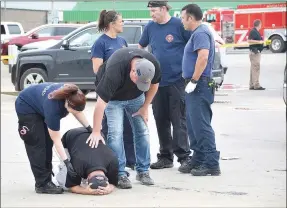  ?? TIMES photograph by Annette Beard ?? Emergency personnel from many department­s quickly arrived on the scene to assist the Pea Ridge Police as they dealt with the death of Officer Kevin Apple Saturday. They consoled and comforted one another in their grief.