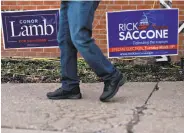  ?? Andrew Harrer / Bloomberg ?? Campaign signs for the candidates for the House of Representa­tives are seen in Carnegie, Pa.