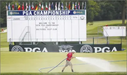  ?? AP PHOTO ?? A member of the grounds crew waters the course during a practice round for the PGA Championsh­ip golf tournament at Baltusrol Golf Club in Springfiel­d Township, N.J.