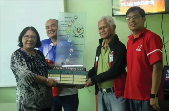  ?? Photo by Danilo Edwardo/KCP ?? SOARING CARDINALS. University of Baguio athletic director Allan Eligado (left) receives the BBEAL Amalio S. Lapaz trophy after amassing 813 points during the 31st season.