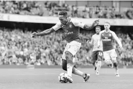  ??  ?? Arsenal’s Danny Welbeck scores their third goal. — Reuters photo