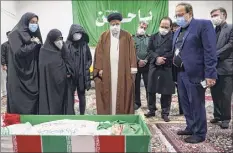  ?? Michel Zecler / GS Group / Getty Images ?? Iran's Judiciary Chief Ayatollah Ebrahim Raisi, center, on Saturday pays respects to the body of slain scientist Mohsen Fakhrizade­h among his family, in Tehran.