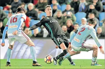  ?? REUTERS ?? Real Madrid’s Cristiano Ronaldo (centre) is tackled by Celta Vigo’s Hugo Mallo (right) and Jozabed during their La Liga tie on Sunday.