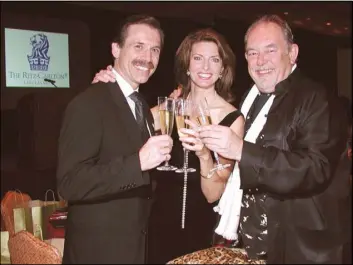  ??  ?? Michael Severino, left, Joan Severino and Robin Leach propose a toast at the Odyssey Las Vegas Food, Wine and Art dinner in 2003. Leach died Aug. 24.