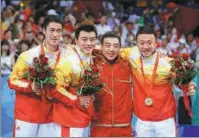  ?? XINHUA ?? Left: Liu Guoliang celebrates winning singles gold at the Atlanta Olympic Games on Aug 1, 1996. Right: Liu poses with players after helming China to a 3-0 victory over Germany in the team final at the Beijing Olympics on Aug 18, 2008.