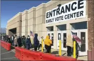  ?? ANDREW WELSH- HUGGINS — THE ASSOCIATED PRESS ?? People stand in a slowly moving line to cast early votes Friday at the Franklin County Board of Elections in Columbus, Ohio.