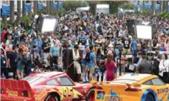  ??  ?? A crowd of people wait to enter the D23 Expo as crews do interviews outside the Anaheim Convention Center in Anaheim, Calif. — AP photos