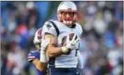  ?? RICH BARNES - THE ASSOCIATED PRESS ?? FILE - In this Dec. 3, 2017, file photo, New England Patriots tight end Rob Gronkowski (87) is tackled by Buffalo Bills strong safety Micah Hyde (23) during the second half of an NFL football game in Orchard Park, N.Y. Good news for Miami Dolphins:...