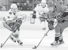  ??  ?? Canucks winger Jake Virtanen tries to hunt down Hurricanes centre Brett Pesce during the first period Friday in Raleigh, North Carolina.