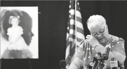  ?? ROSS D. FRANKLIN/AP ?? DEBBIE CARLSON, MOTHER OF MURDERED 8-YEAR-OLD Vicki Lynne Hoskinson, wipes away a tear as she speaks at a news conference after Frank Atwood was put to death by lethal injection at the Arizona state prison Wednesday, in Florence. Atwood was convicted in the 1984 killing of Hoskinson and was executed in what was the state’s second execution since officials started carrying out the death penalty in May after a nearly eight-year hiatus.