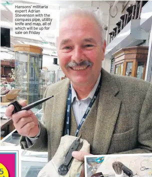  ??  ?? Hansons’ militaria expertadri­an Stevenson with the compass pipe, utility knife and map, all of which will be up for
sale on Friday