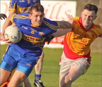  ??  ?? Adrian Flynn of Gusserane breaks away from Sarsfields attacker Eoin Roche.