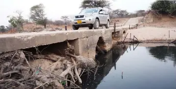  ??  ?? Siltation has blocked the tunnels of the bridge on Mudzi River which will result in water flowing above Mudzi Bridge.— Picture: Justin Mutenda