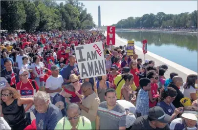  ?? PAUL J. RICHARDS, AFP/GETTY IMAGES VIA NEWSCOM ?? Thousands of people line the reflecting pool near the Lincoln Memorial while listening to speakers at the 50th anniversar­y of the March on Washington for civil rights in 1963. “You cannot stand by. You cannot sit down. You’ve got to stand up.” said...