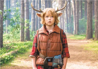  ?? NETFLIX ?? Gus (Christian Convery) is a deer-boy who emerges from his protected forest home and ends up in the company of a wanderer (Nonso Anozie) in Netflix’s “Sweet Tooth.”