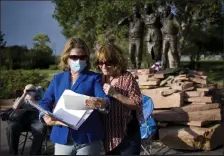  ?? Timothy Hurst / Staff Photograph­er ?? Christophe­r Faughnan’s sisters Maureen Stines, left, and Diane Barnes look through a folder of pictures and other keepsakes of Christophe­r's before a memorial for him on Sept. 11, 2020, in Broomfield.