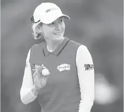  ??  ?? Sarah Jane Smith gives the crowd a wave after a birdie putt on the 18th hole during the second round of the U.S. Women’s Open.