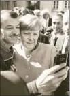  ?? AFP ?? An asylum seeker takes a selfie with the German chancellor