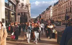  ??  ?? Pedestrian­s and shoppers walk along Regents Street in London on Monday as non-essential retailers reopened.