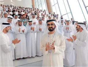  ?? — Wam ?? VISION RECHARGED: Sheikh Mohammed, Sheikh Hamdan bin Mohammed bin Rashid Al Maktoum, Crown Prince of Dubai, ministers and officials applaud after the signing of the National Charter.