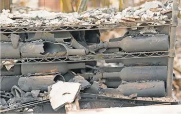  ?? ERIC RISBERG, AP ?? Burned bottles lay among the debris at Signorello Estate winery in Napa, Calif., on Tuesday.