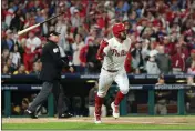  ?? TIM NWACHUKWU — GETTY IMAGES ?? The Phillies’ Kyle Schwarber (12) tosses his bat after hitting a solo home run during the first inning against the Padres in Game 3of the NL Championsh­ip Series at Citizens Bank Park on Friday in Philadelph­ia.