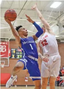  ?? STAFF PHOTO BY MATT HAMILTON ?? Baylor’s Al Peciulis, right, defends as McCallie’s Eric Rivers shoots during Friday night’s game at Baylor. Rivers scored 22 points.