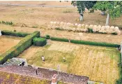  ?? ?? Hay bales run along the entire width of Mrs Turner’s back garden