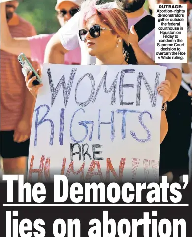  ?? ?? OUTRAGE: Abortion- rights demonstrat­ors gather outside the federal courthouse in Houston on Friday to condemn the Supreme Court decision to overturn the Roe v. Wade ruling.