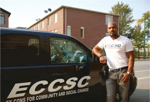  ??  ?? Tyrone Muhammad, founder of Ex-Cons for Community and Social Change, with one of the fleet of SUVs he has acquired to patrol violent parts of Chicago.