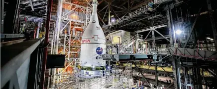  ?? Frank Michaux/NASA ?? The Orion spacecraft is lifted above the Space Launch System rocket at NASA’s Kennedy Space Center in Florida on Oct. 20.