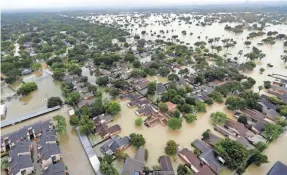  ?? DAVID J. PHILLIP/AP ?? The flooding brought by Hurricane Harvey last summer has raised questions about suburban sprawl and the paving of floodplain and drainage areas.