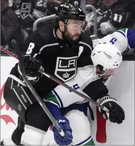  ?? PHOTOS BY MARCIO JOSE SANCHEZ — THE ASSOCIATED PRESS ?? Kings defenseman Drew Doughty (8) presses Canucks center J.T. Miller against the boards during the first period of Saturday night's game at Crypto.com Arena.